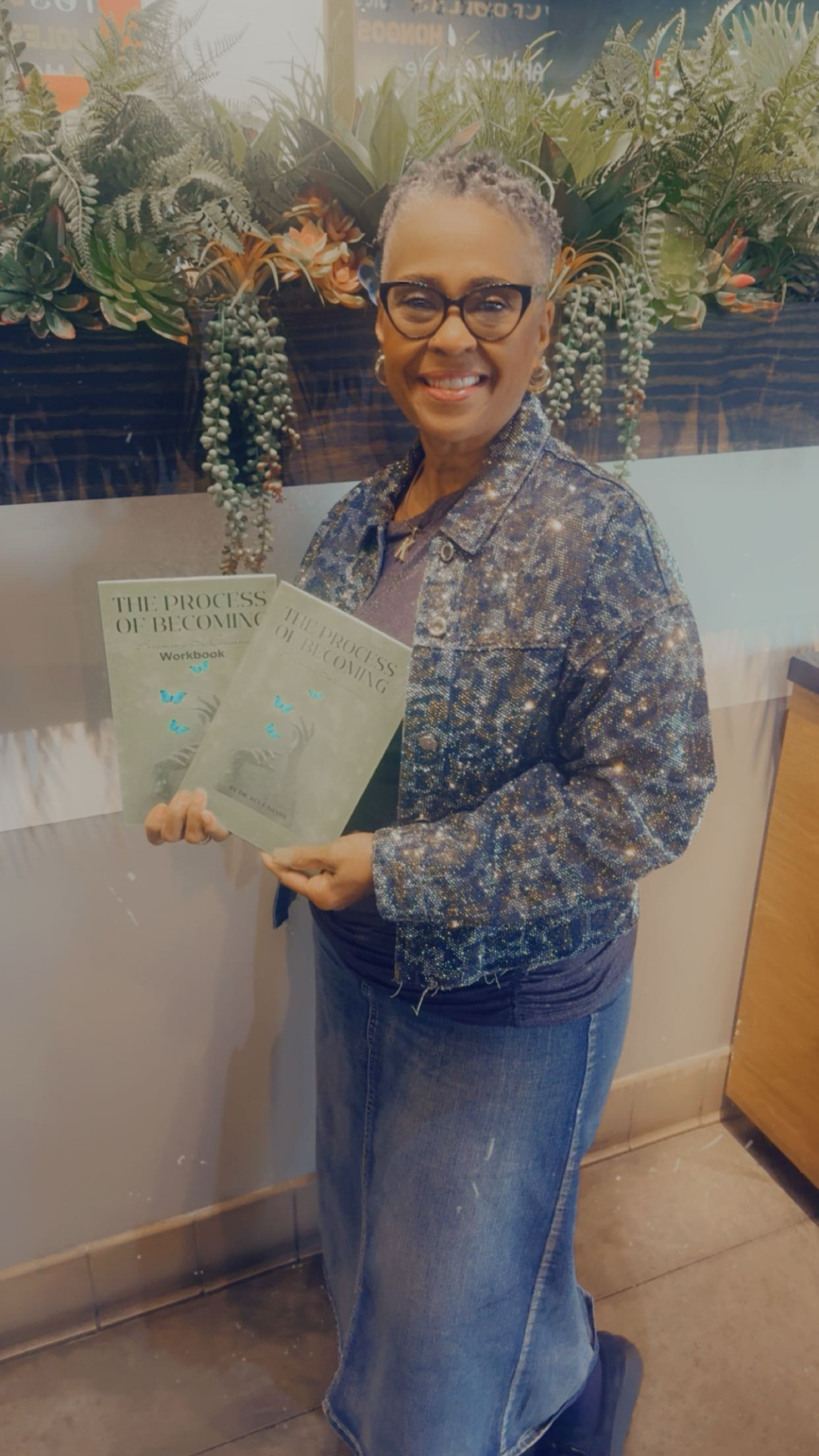 Woman in sparkly jacket holding books